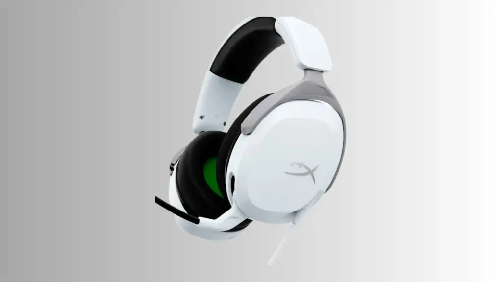 HyperX CloudX wired gaming headset with detachable microphone placed next to an Xbox controller on a desk with neutral background