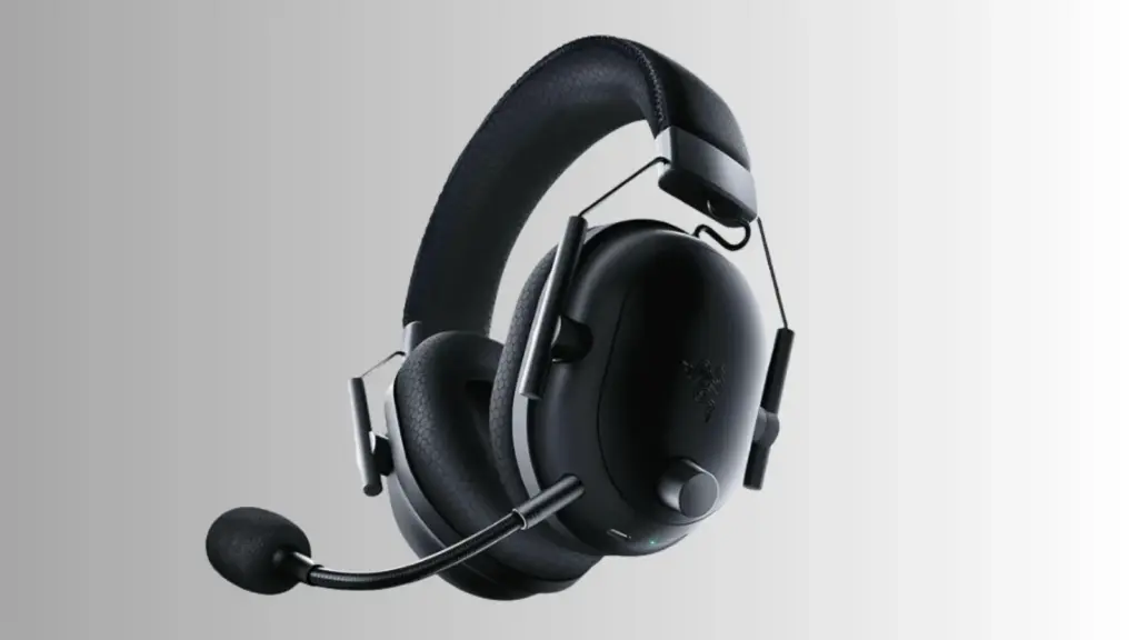 Razer BlackShark V2 Pro wireless gaming headset positioned on a desk beside a gaming controller with neutral background