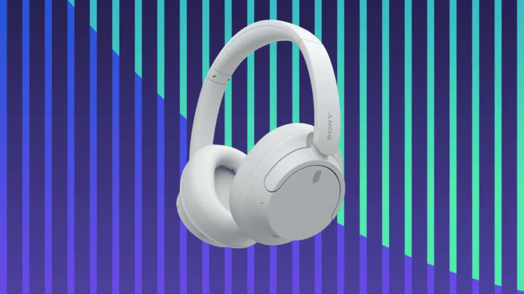 Sony over-ear wireless headphones in light gray displayed against a bold blue and teal striped background.