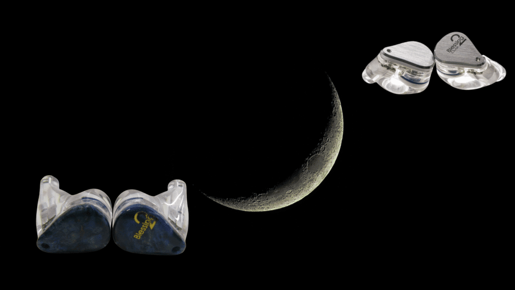 moondrop Blessing 2 in-ear monitors displayed against a dark background with a crescent moon centered, highlighting the transparent resin shells and metal faceplates