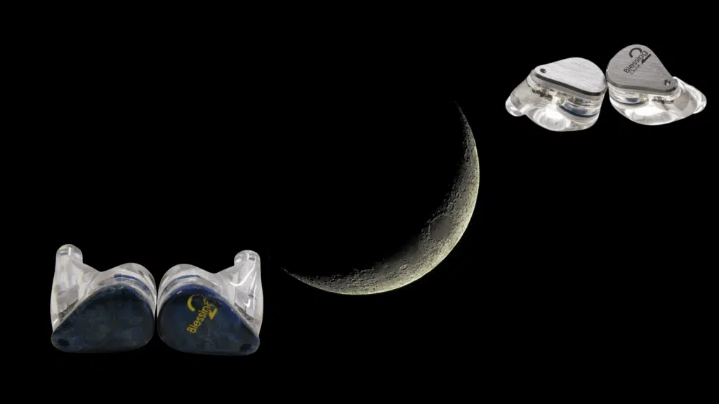 moondrop Blessing 2 in-ear monitors displayed against a dark background with a crescent moon centered, highlighting the transparent resin shells and metal faceplates