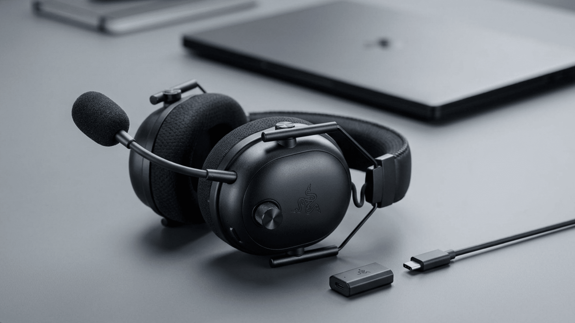 black gaming headset with detachable mic and textured ear cushions on clean minimal background