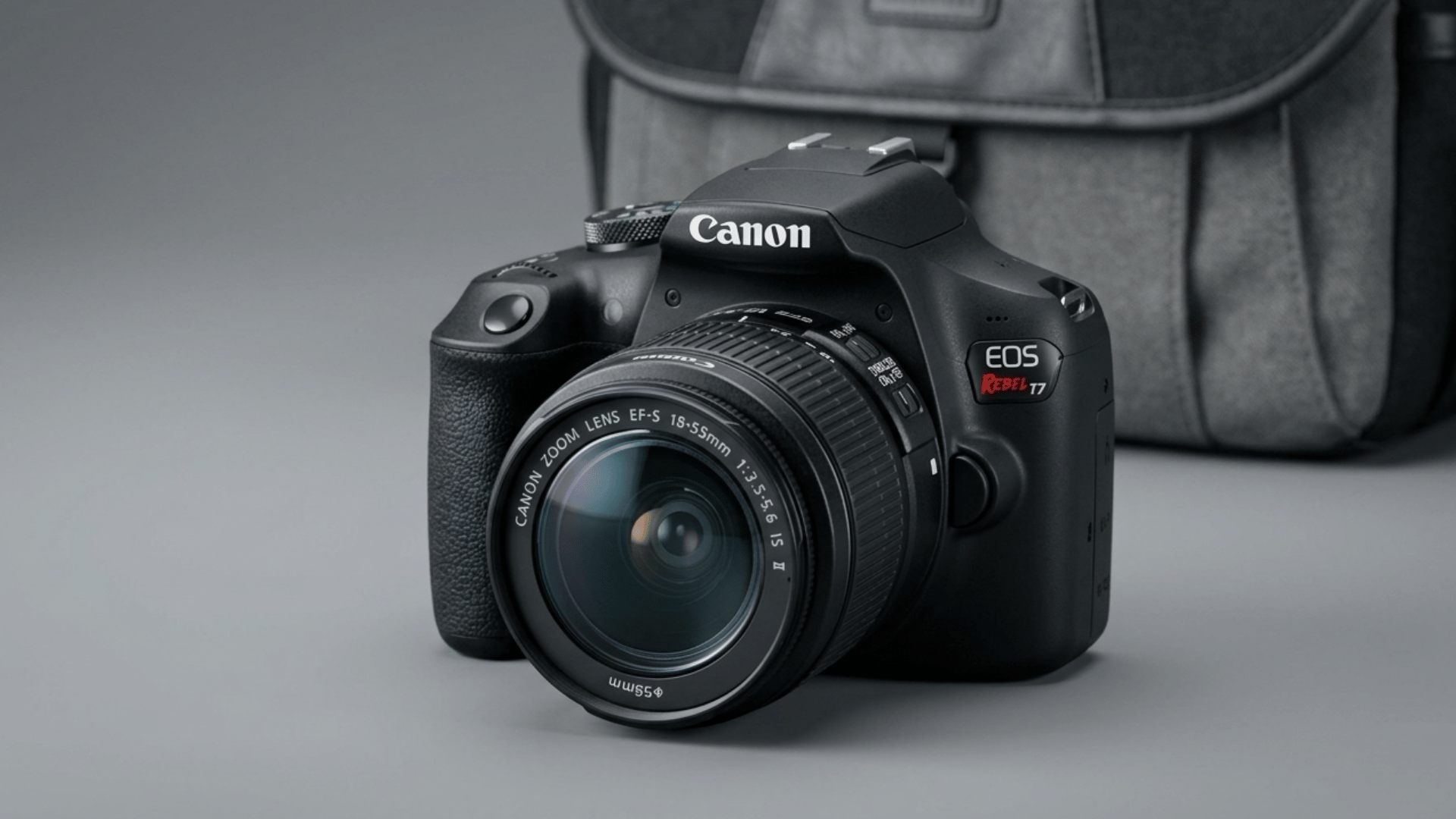 canon eos rebel t8i on grey surface with studio light and blurred camera bag background