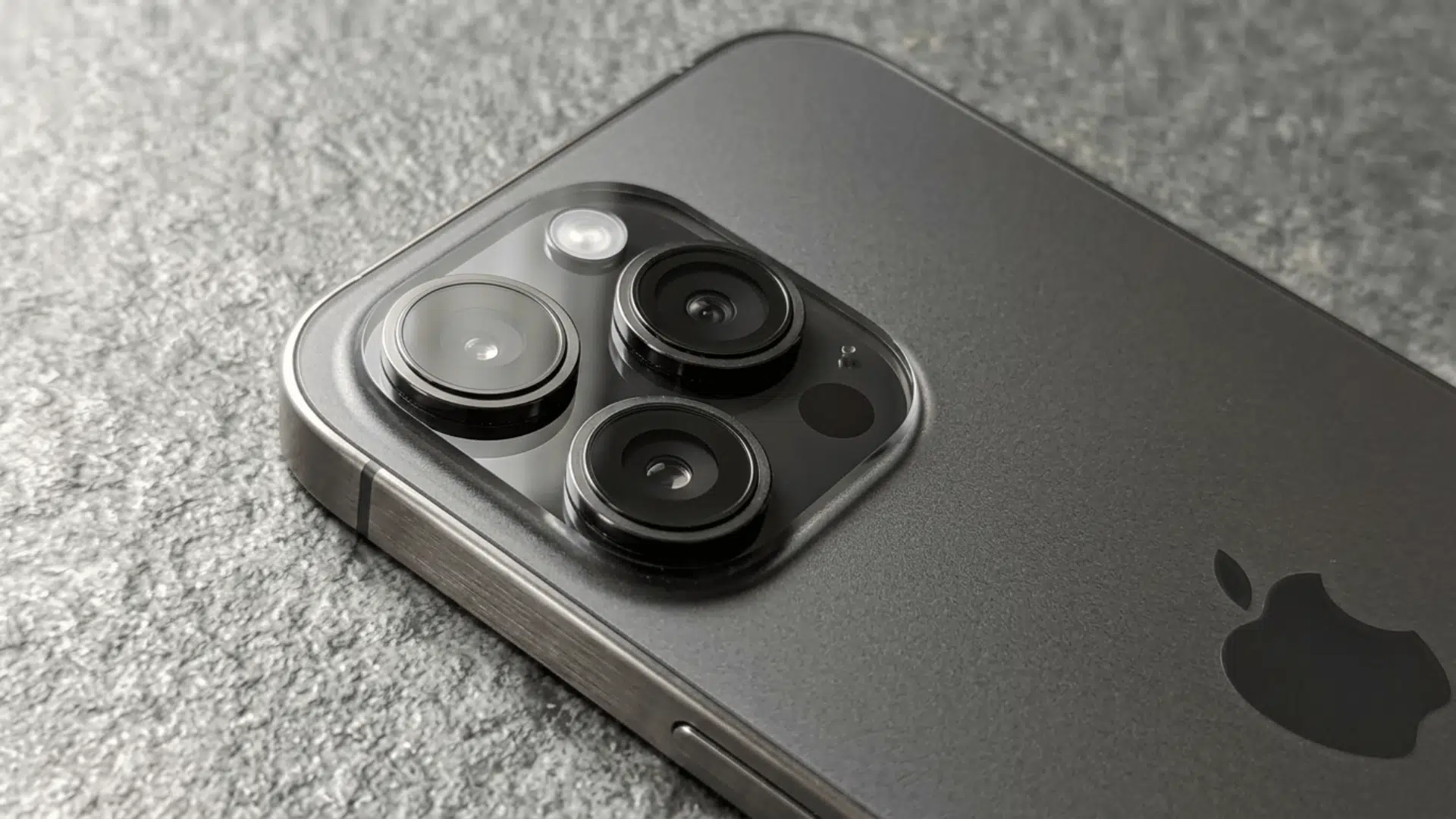 close-up of iPhone 16 Pro triple camera lenses showing detailed design and premium finish on the back panel.