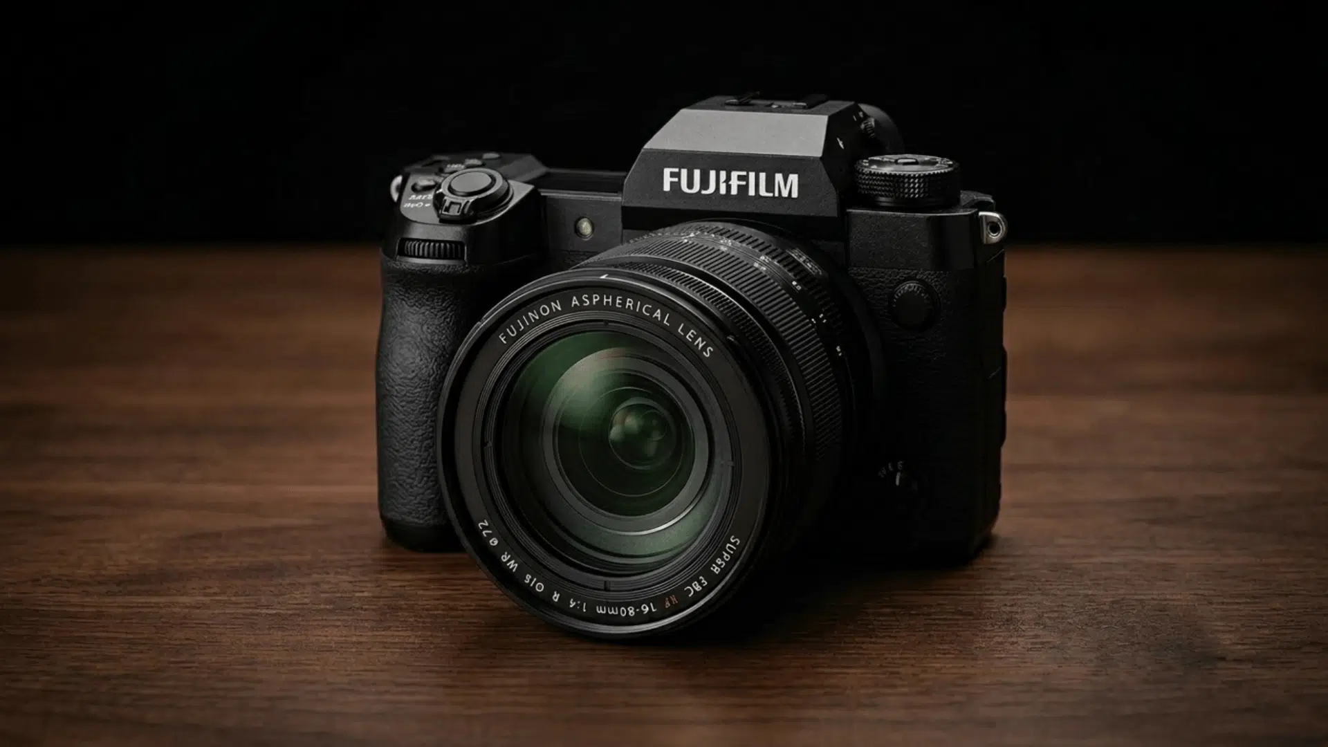 fujifilm mirrorless camera on wooden surface with dark background and focused product lighting