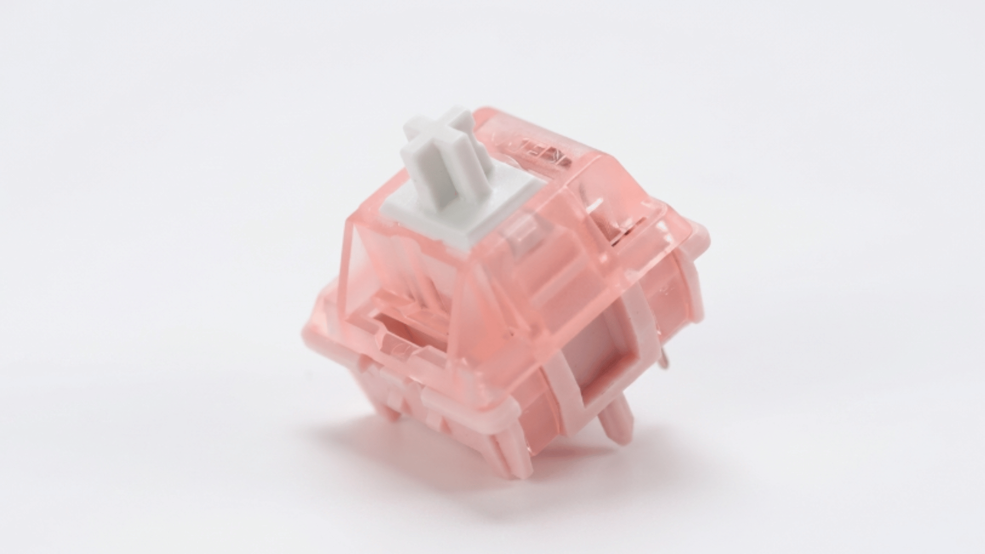 kbdiy sakura switch close up showing soft pink housing and smooth design placed on simple background