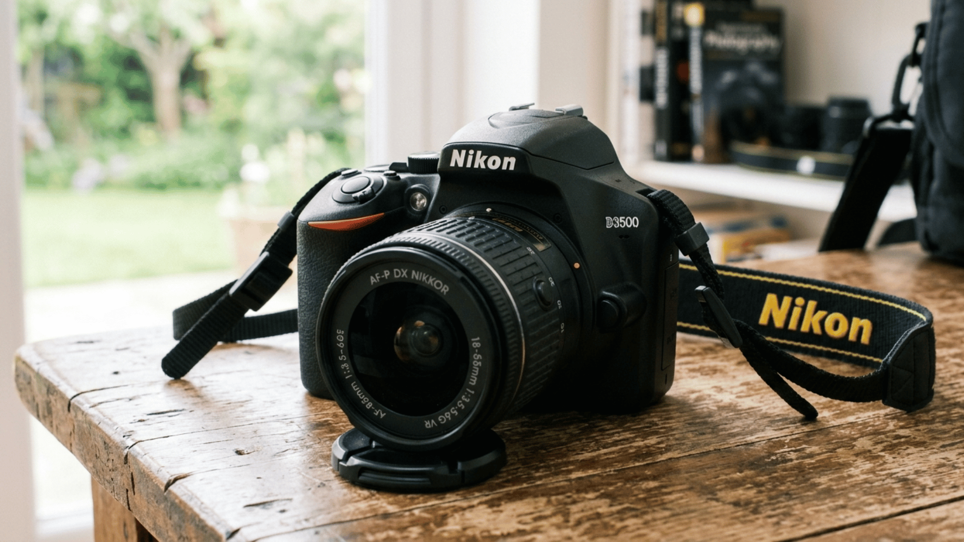nikon D3500 entry level DSLR camera with kit lens on table, ideal for beginners looking for simple and reliable photography setup