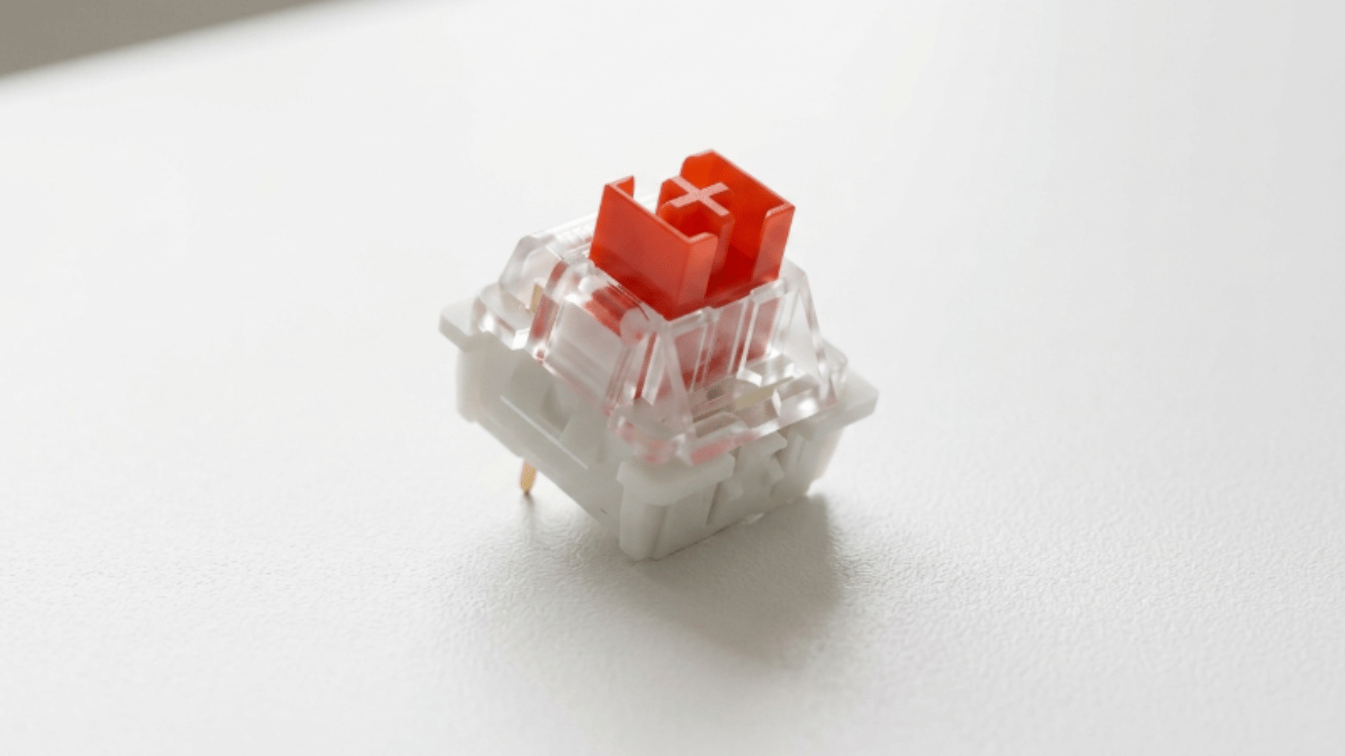 outemu red switch close view with red stem and black housing placed on plain background surface