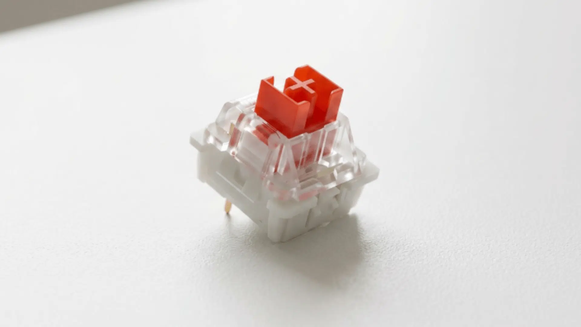 outemu red switch close view with red stem and black housing placed on plain background surface