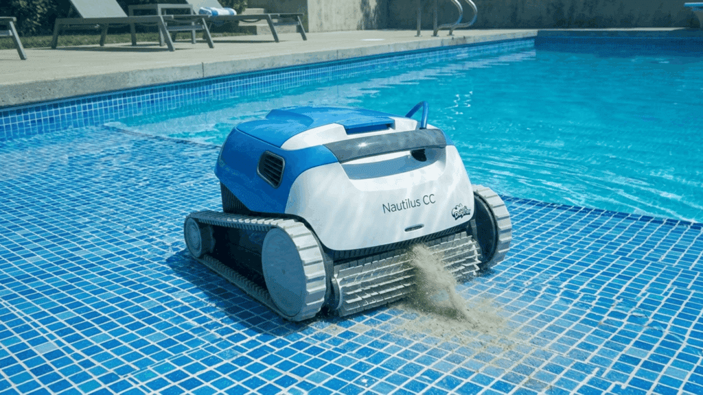 robotic pool cleaner vacuuming debris on tiled pool floor with strong suction and rotating brushes in a clear blue swimming pool.