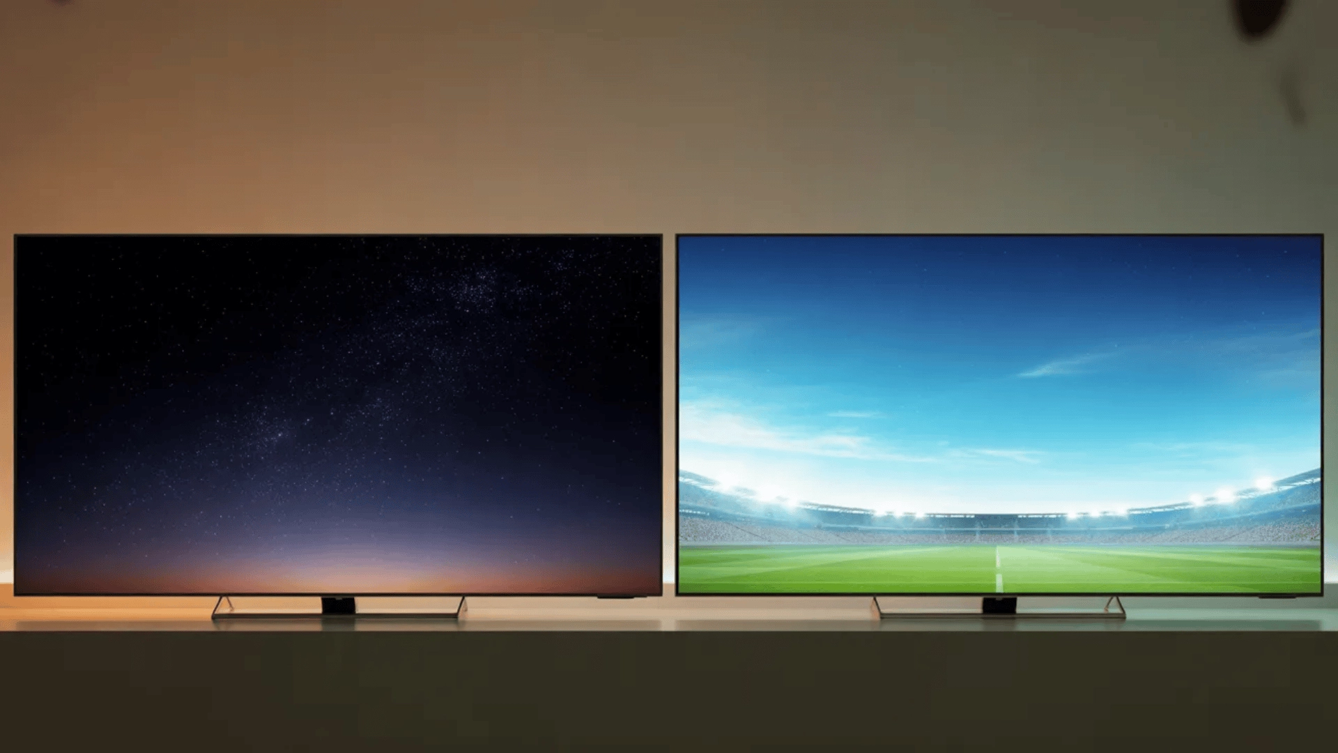 Two TVs side by side showing dark night scene and bright sports scene