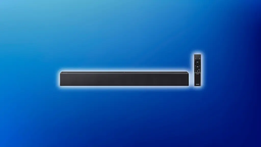 Long black Samsung soundbar with a front speaker grille, paired with a slim vertical remote, displayed on a blue gradient background with a soft glow effect.