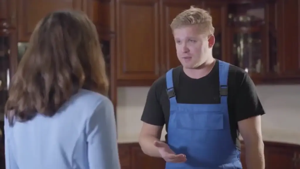 Repair technician talking to a homeowner inside a kitchen