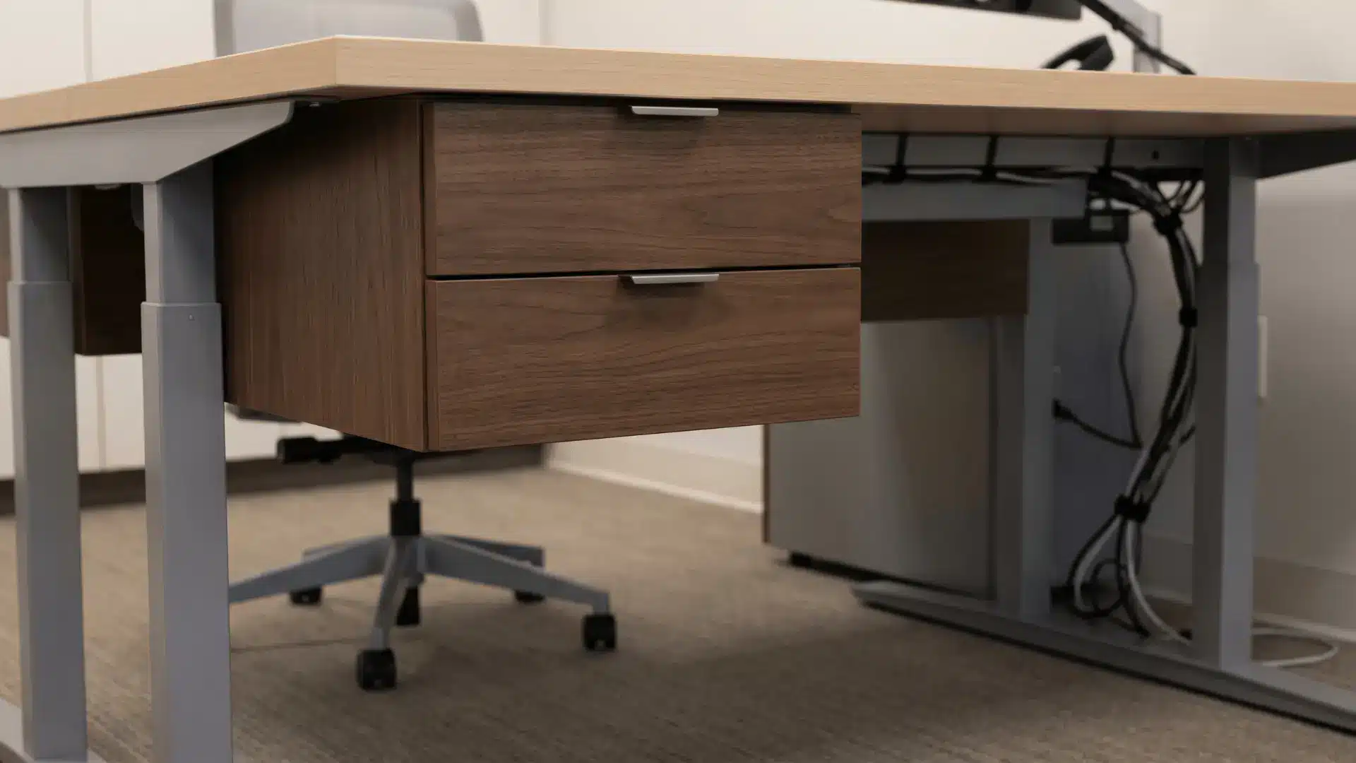 Compact drawers fitted under a desk with clear leg space below