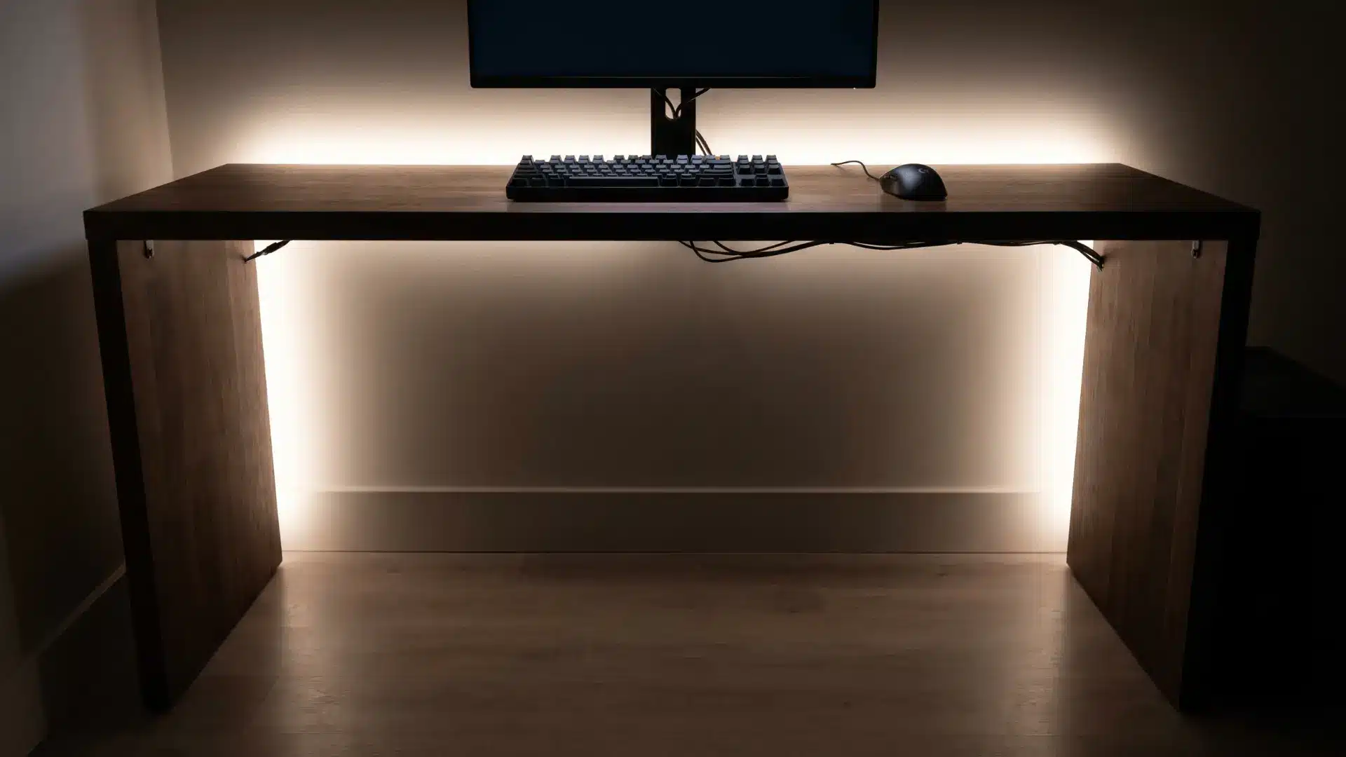 Desk with soft LED lighting underneath creating a subtle glow on the floor