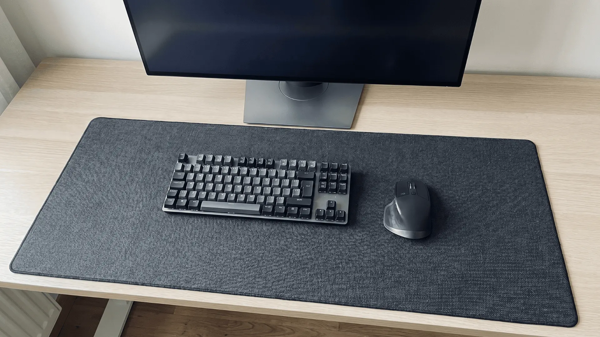 Large desk mat covering most of a desk with keyboard and mouse placed on it