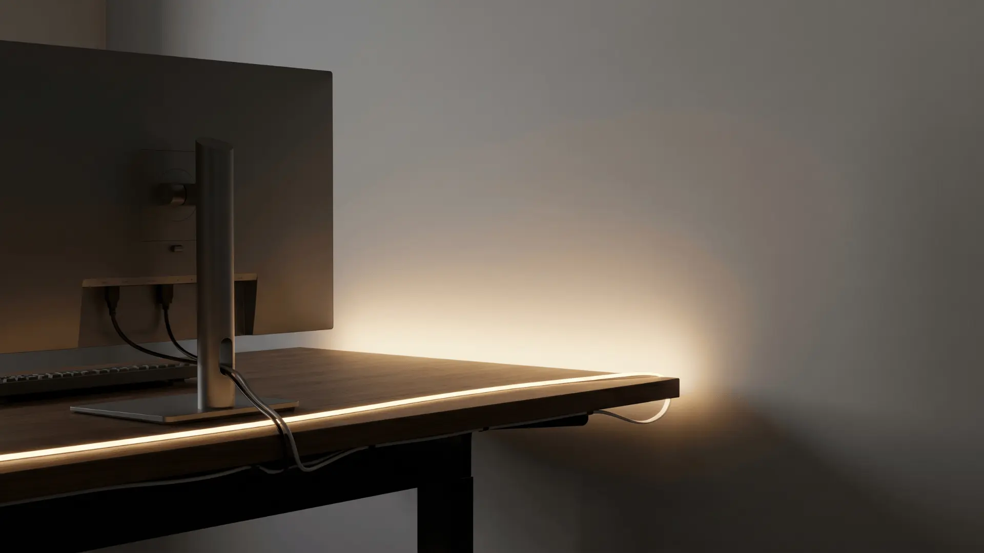 LED strip installed behind a desk creating soft indirect lighting on the wall