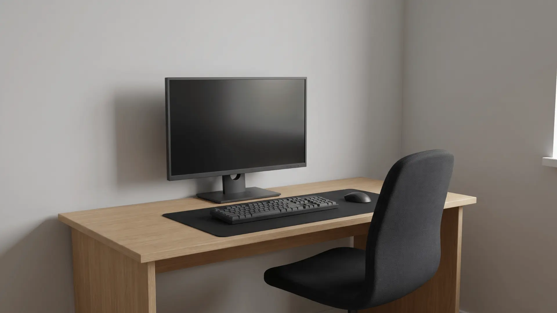 Simple desk setup with monitor, keyboard, mouse, and chair with no extra accessories