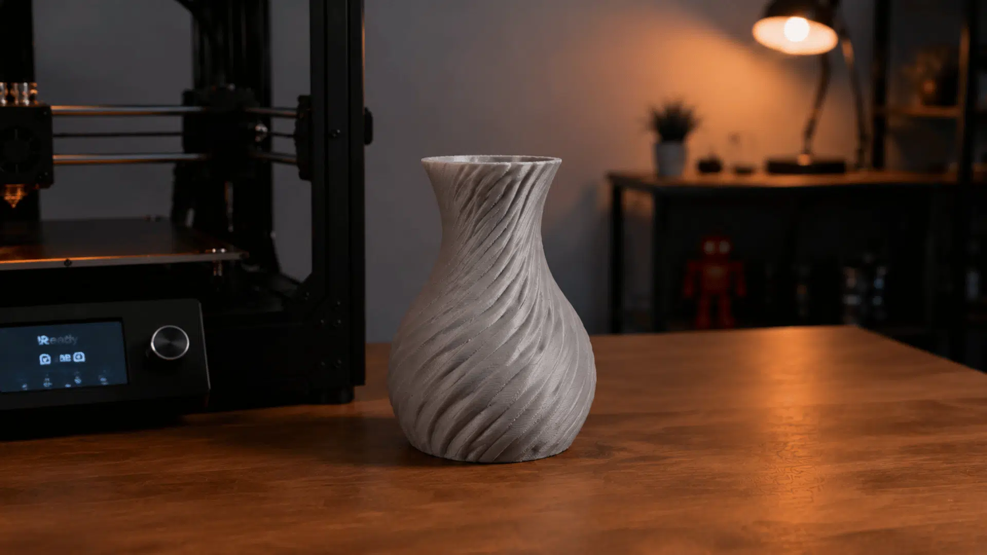 a 3d printing workspace showing a finished printed vase in indoor setting studio light setup