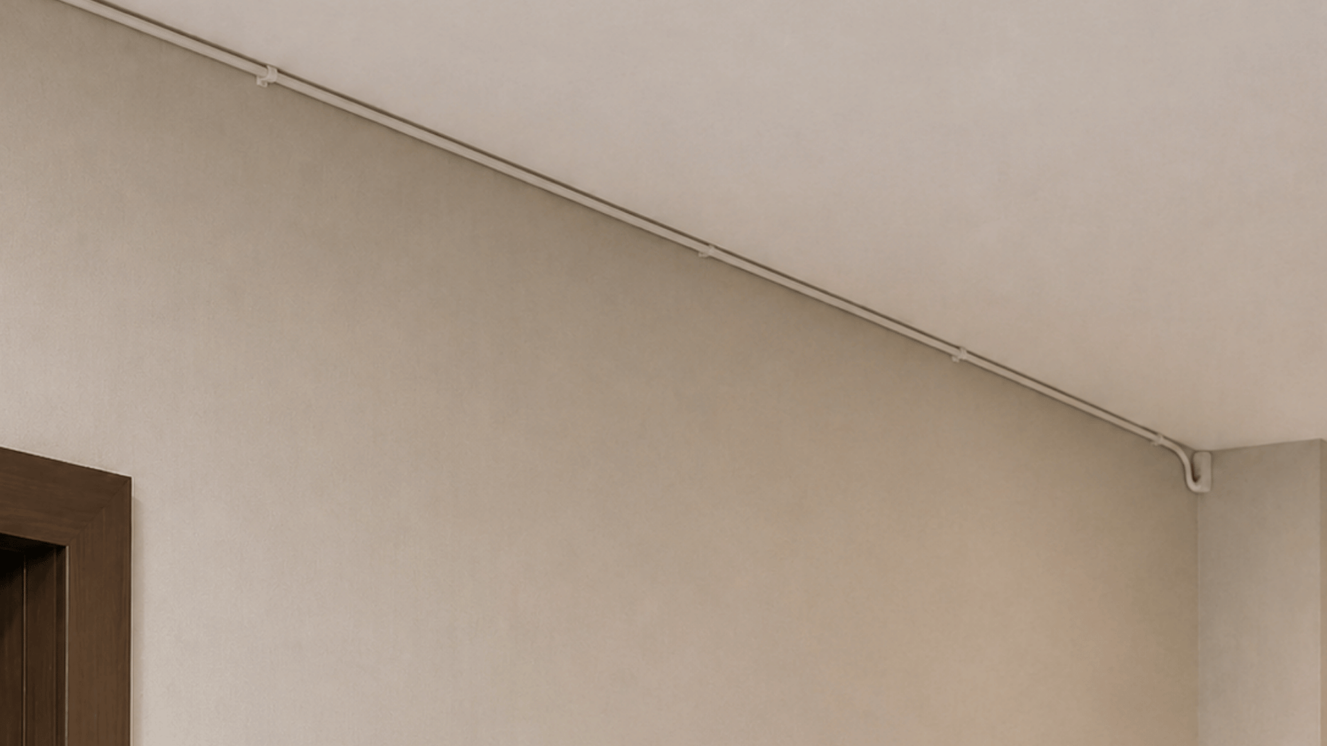 a modern corridor with subtle details of running white cable wire along the length of roof fixed using hooks and nails in an indoor setting white walls and upper corner of door visible