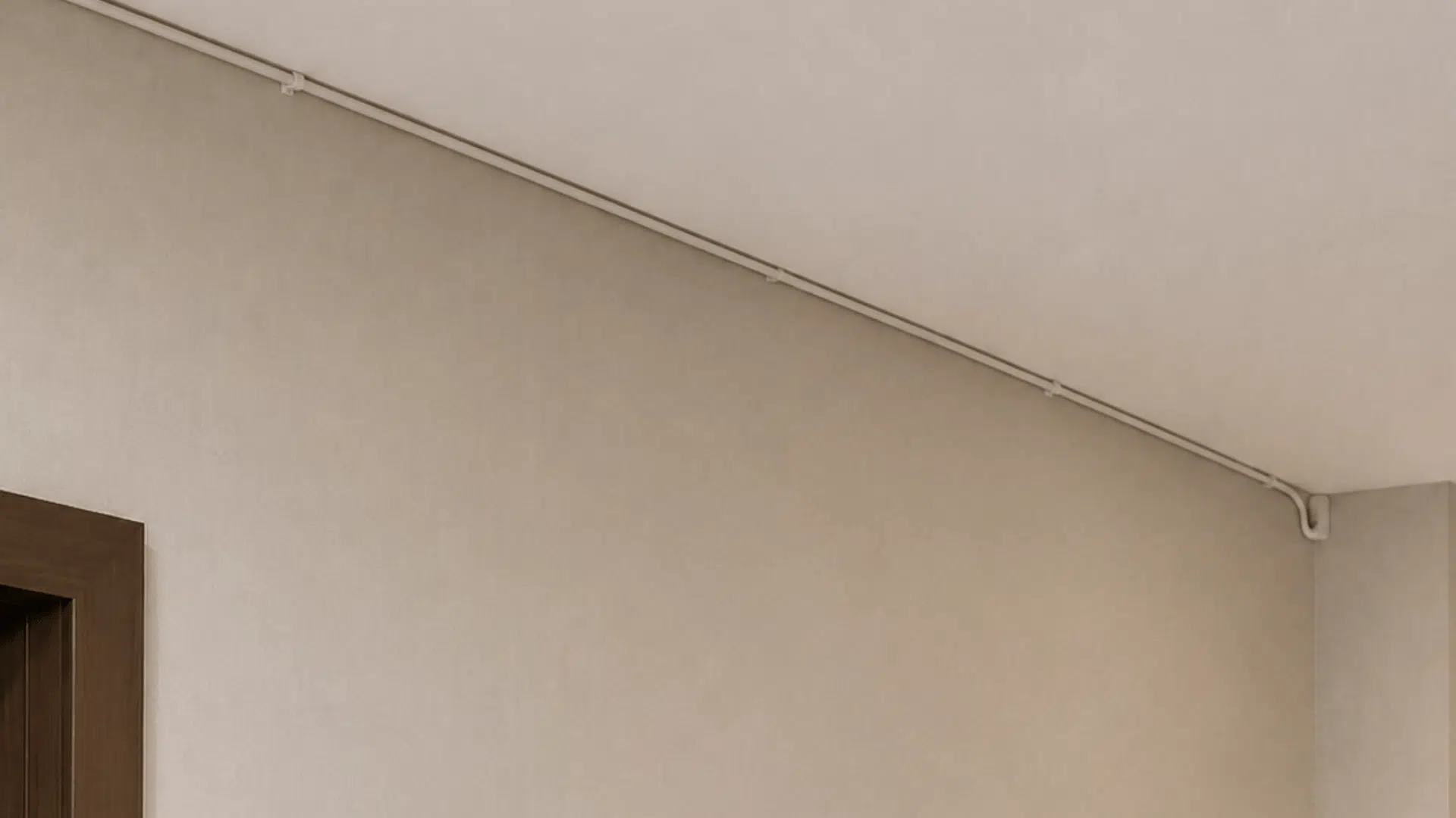 a modern corridor with subtle details of running white cable wire along the length of roof fixed using hooks and nails in an indoor setting white walls and upper corner of door visible