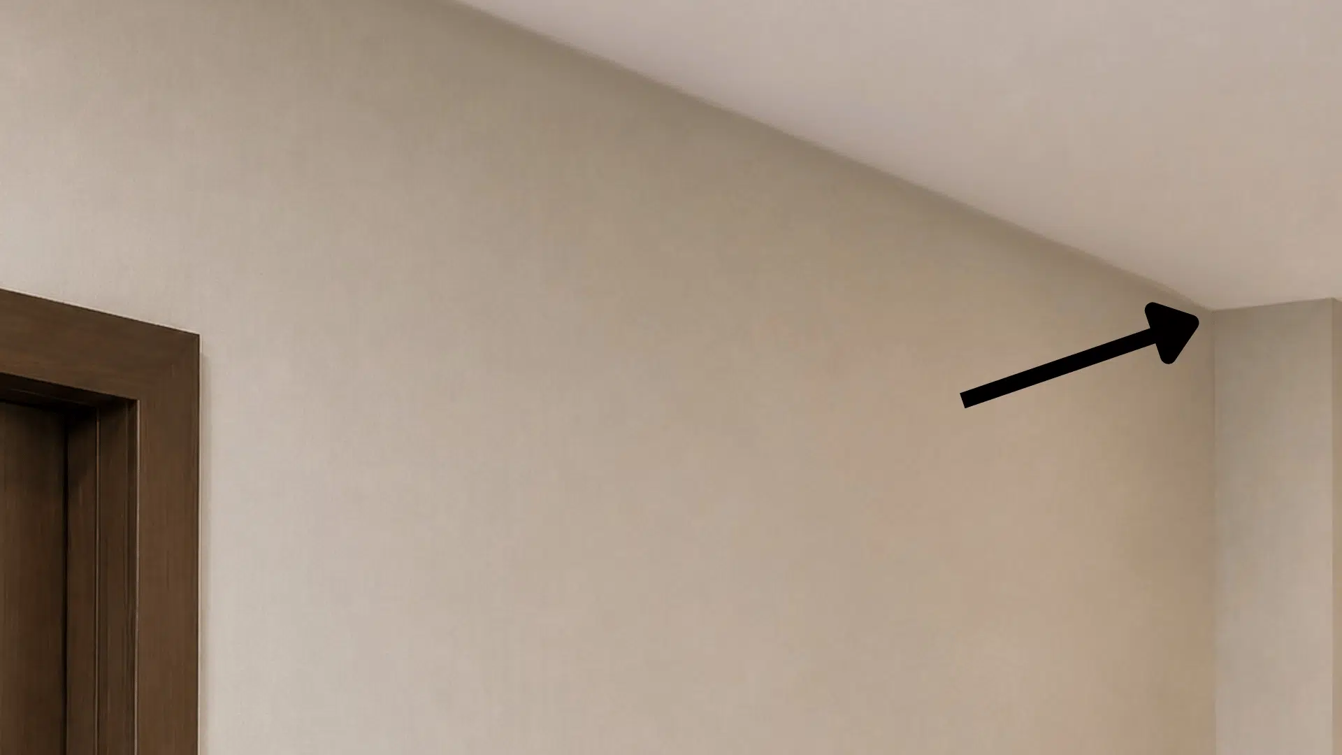 arrow pointing towards the corner of the corridor wall where the cctv camera is to be installed in minimal lighting and off white wall with indoor setting