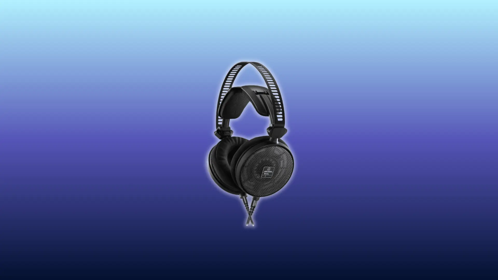Image of Audio-Technica ATH-R70x headphones, over-ear open-back design in black with perforated lightweight headband and large ear cups, displayed against a gradient blue background.