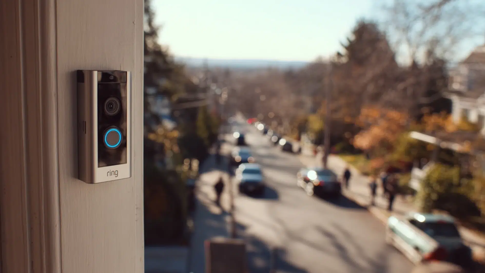 ring video doorbell on a suburban front door with a busy street and passing cars in the background triggering constant motion detection