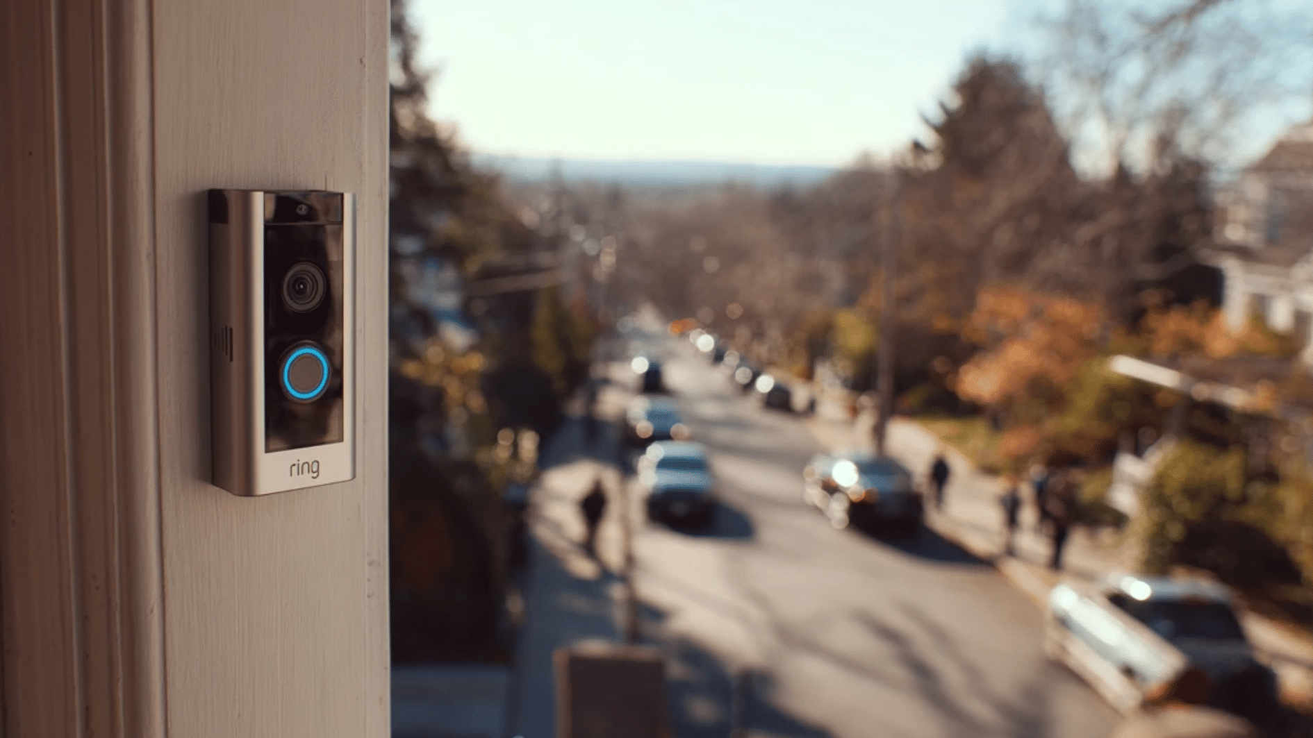 ring video doorbell on a suburban front door with a busy street and passing cars in the background triggering constant motion detection