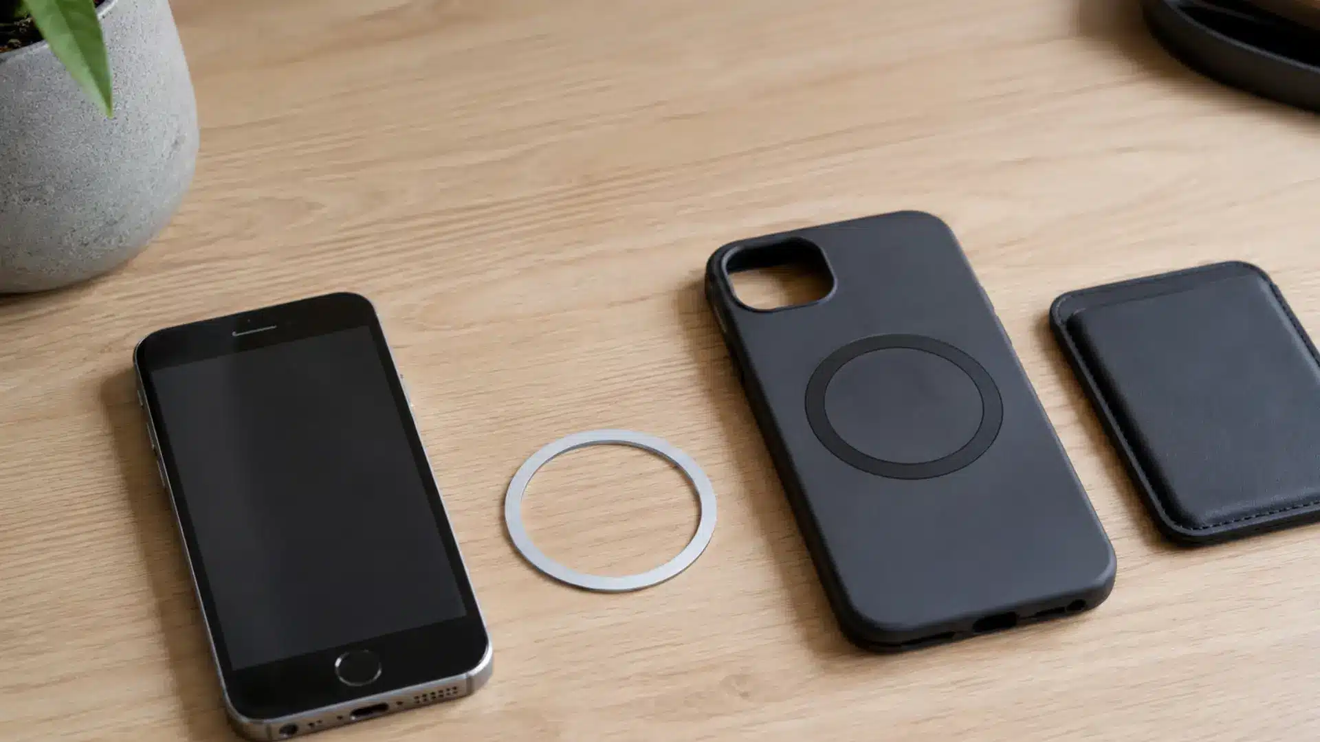 Older iPhone beside a magnetic adapter ring and case used to attach compatible magnetic accessories
