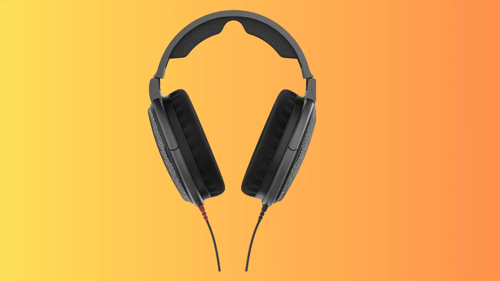 Black over-ear headphones with open-back earcups on a yellow-orange gradient background