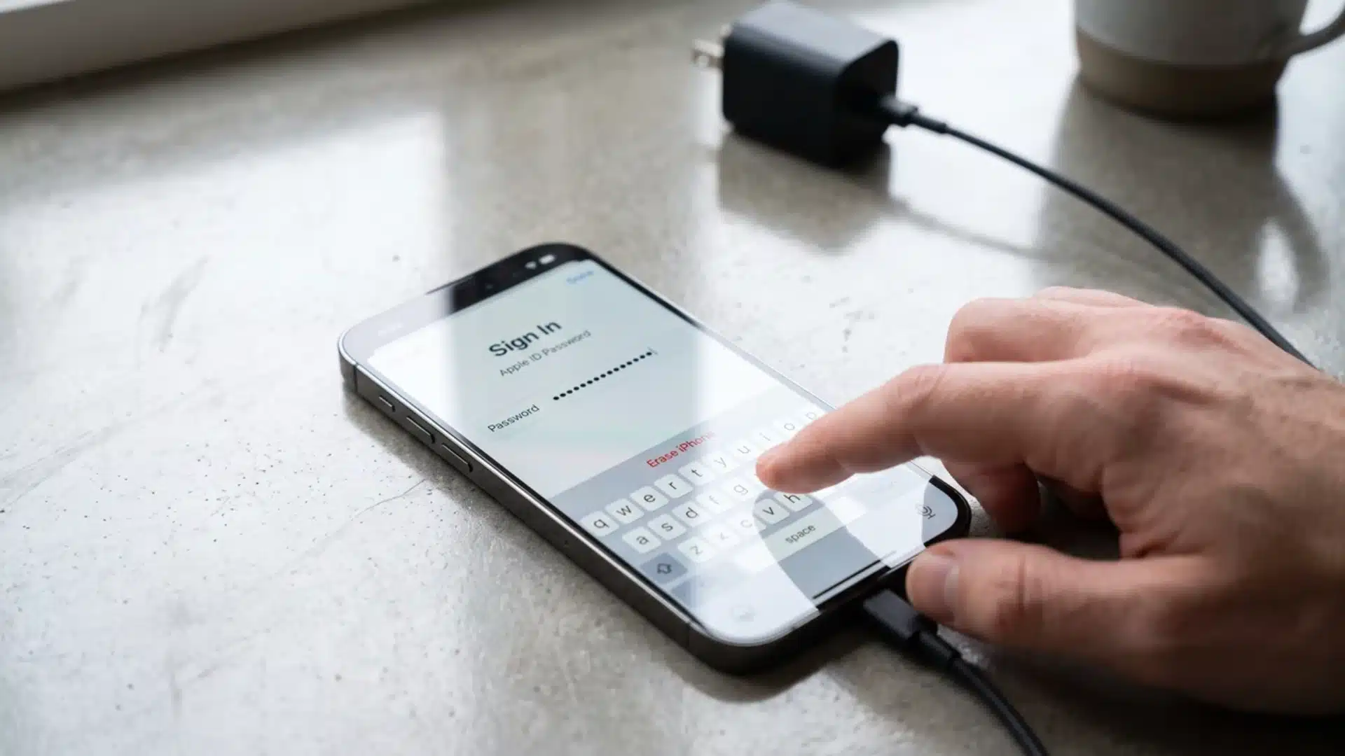A person typing an Apple ID password on an iPhone to confirm device erasure.