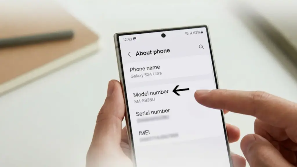 person holds a Samsung phone displaying the "About Phone" menu with "Model number SM-S928U" highlighted clearly on screen
