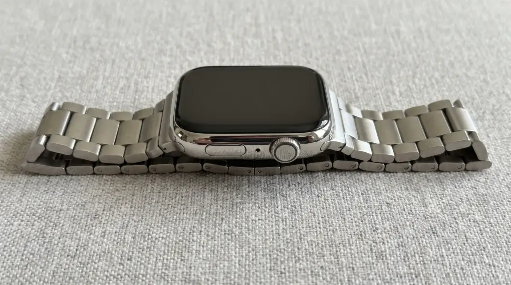 Smartwatch with stainless steel link bracelet showing the case, links, and band connection area