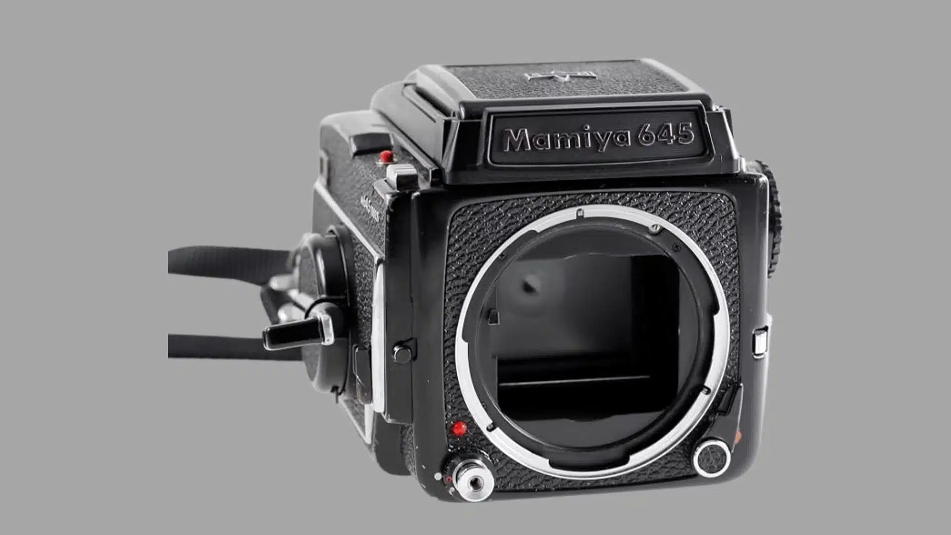 Three-quarter view of a black Mamiya 645 medium-format film camera body without a lens.
