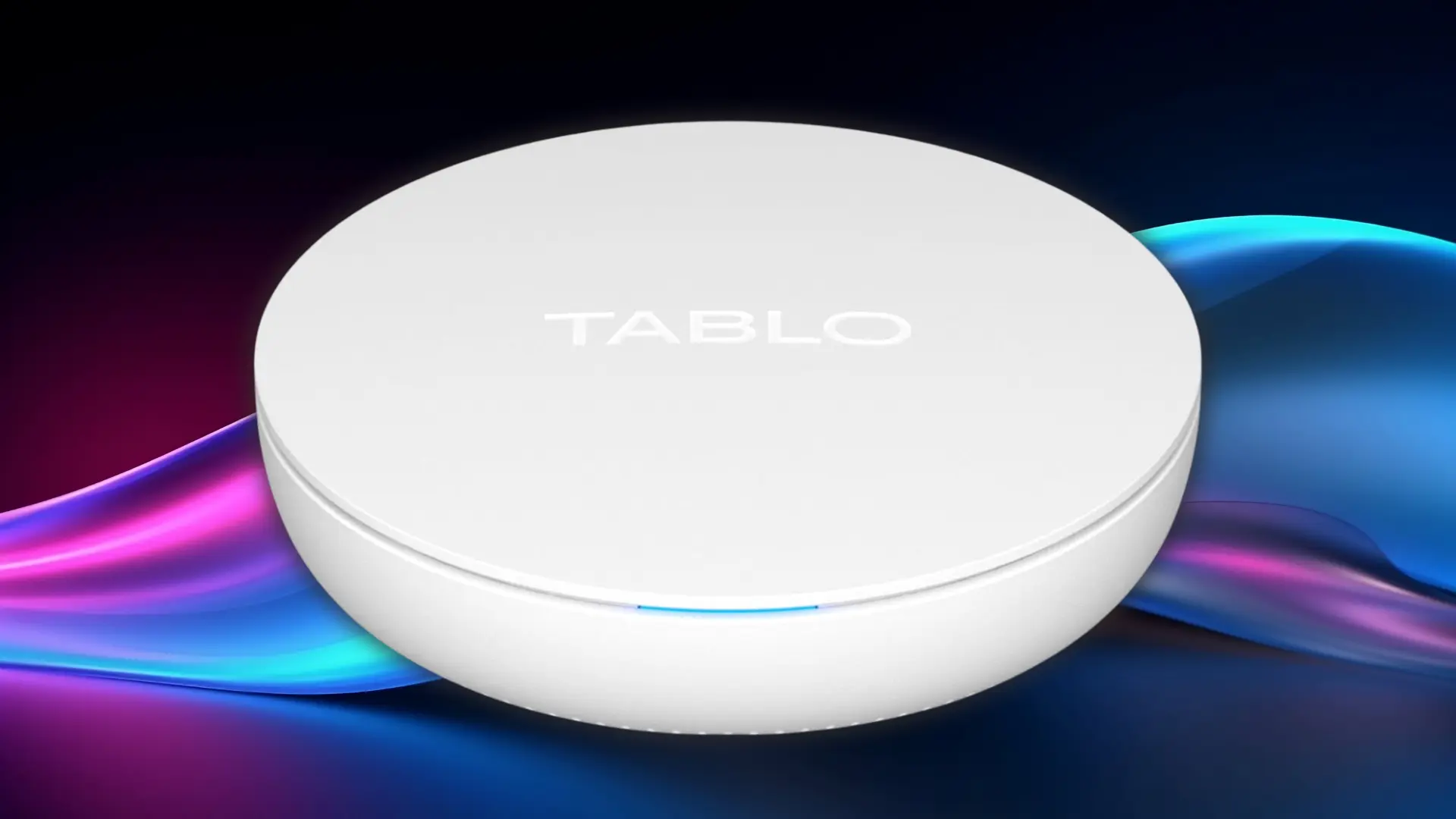 White circular Tablo TV DVR with a blue status light on a coloured background
