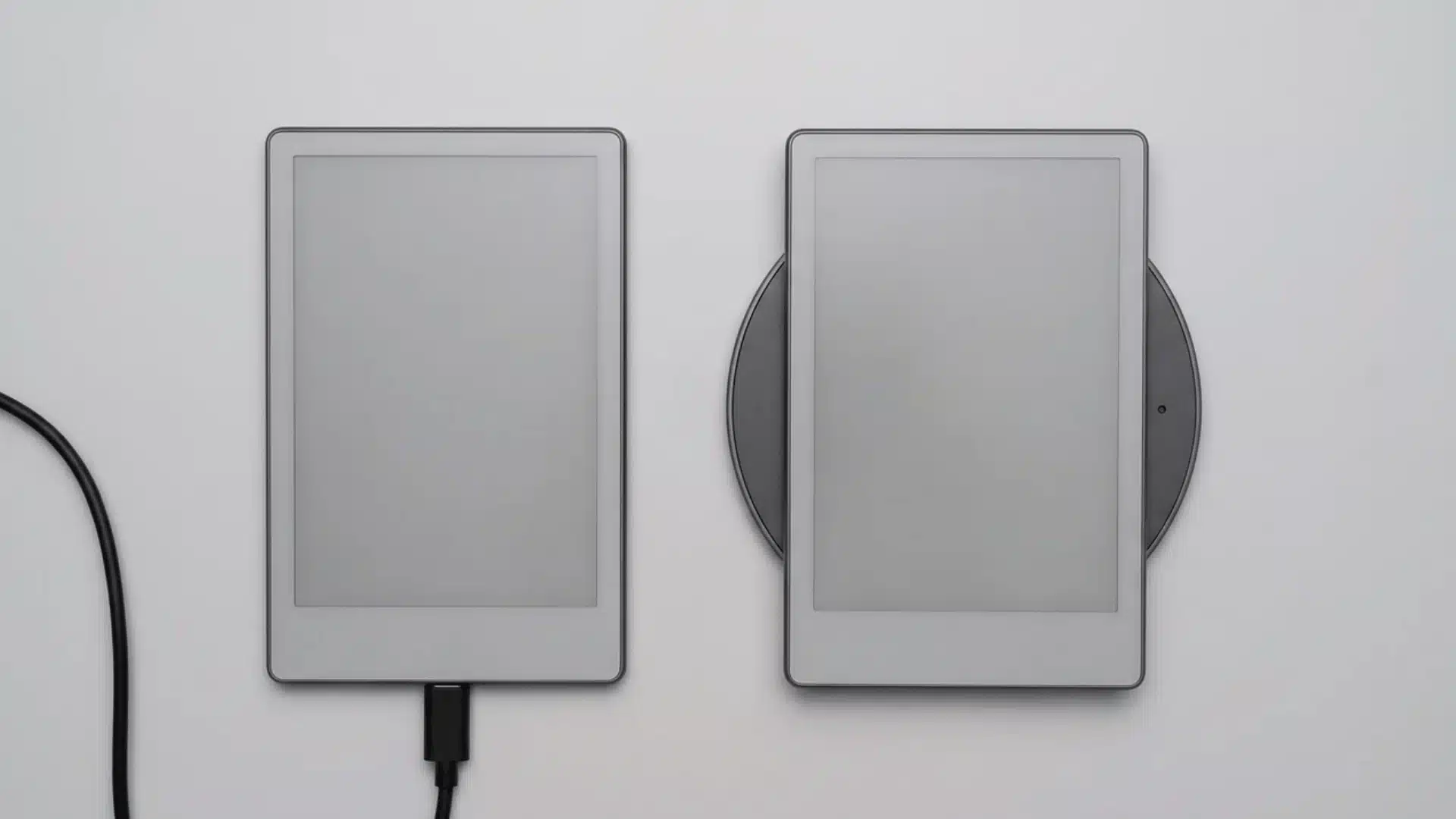 Two e-readers distinguished by USB-C cable charging and a separate wireless charging dock