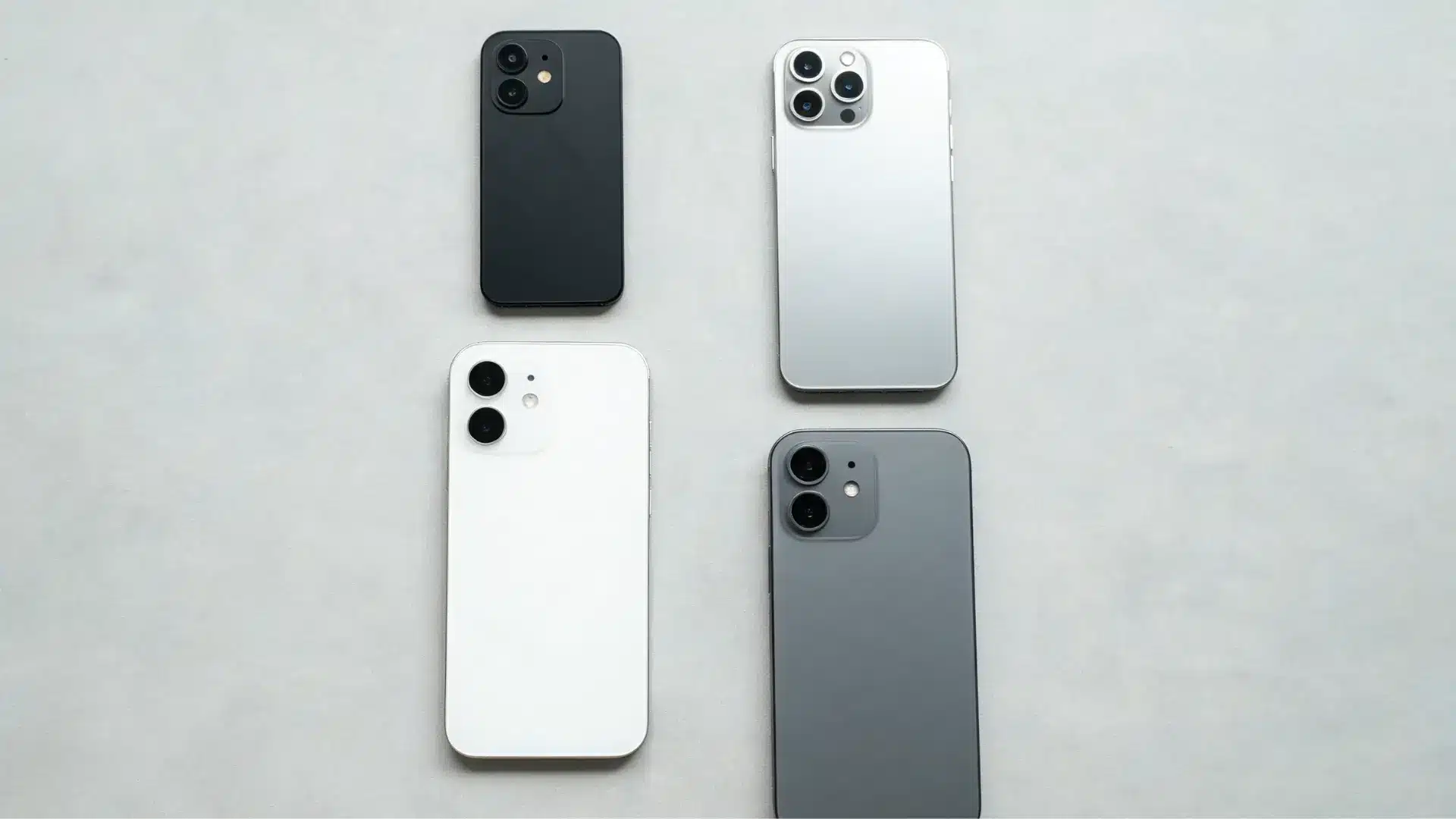 Four smartphones with different sizes and rear camera arrays standing in a row