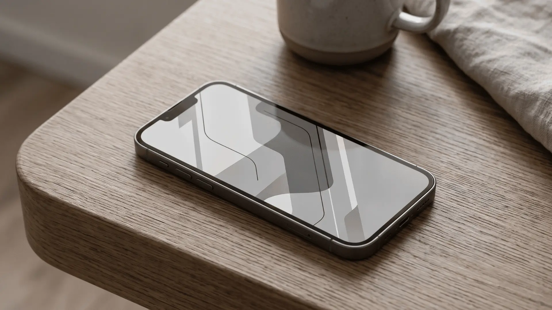 Smartphone with a fully grayscale display resting in a simple home setting.