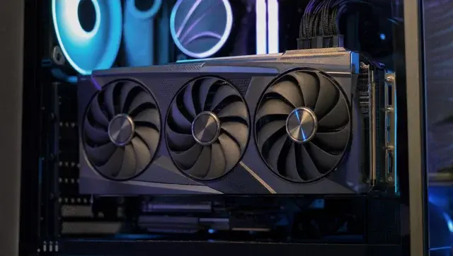 graphics card with three cooling fans installed inside a desktop pc case showing GPU hardware setup